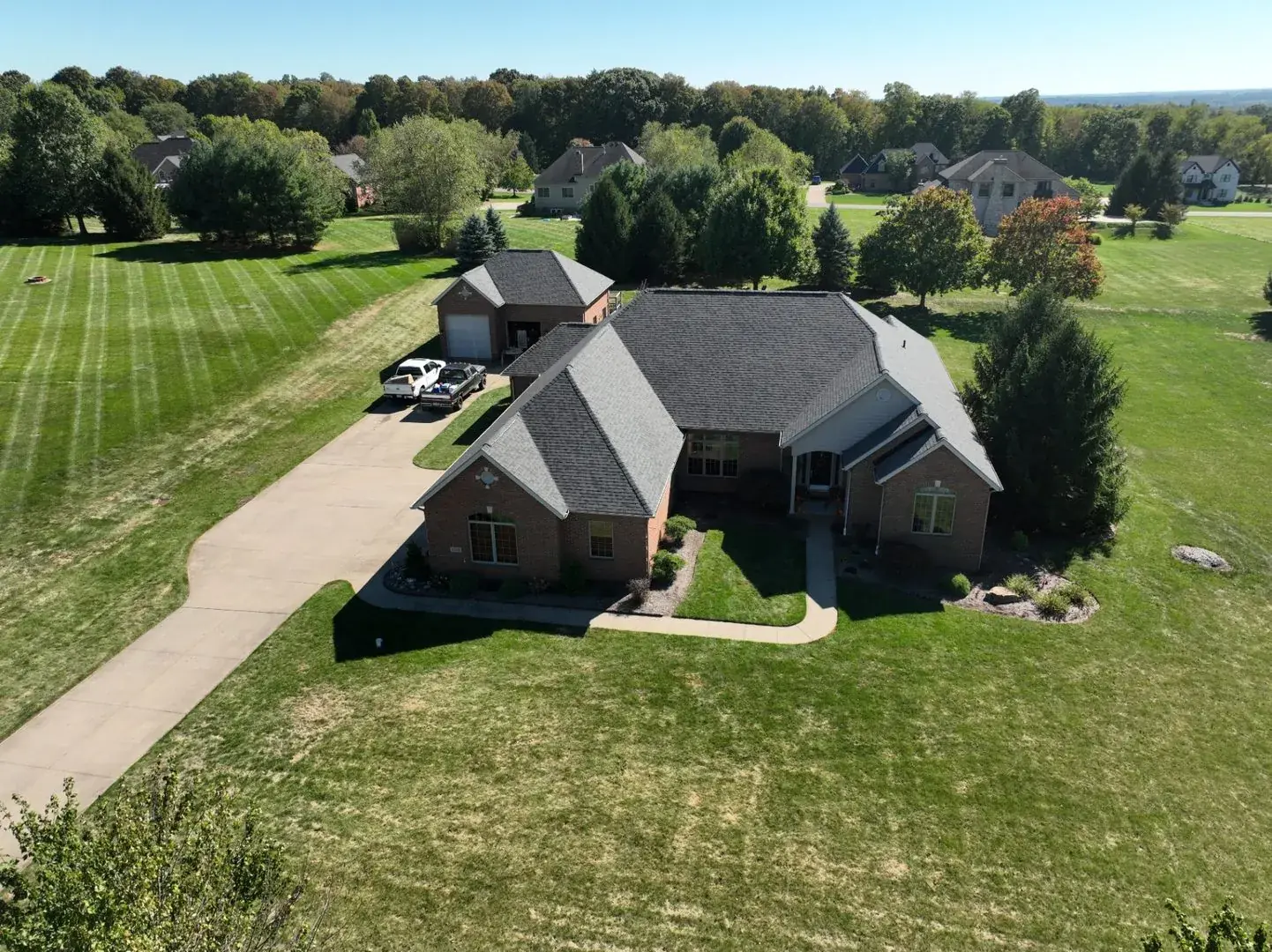 Brick estate with new roof. Sunny day drone shot
